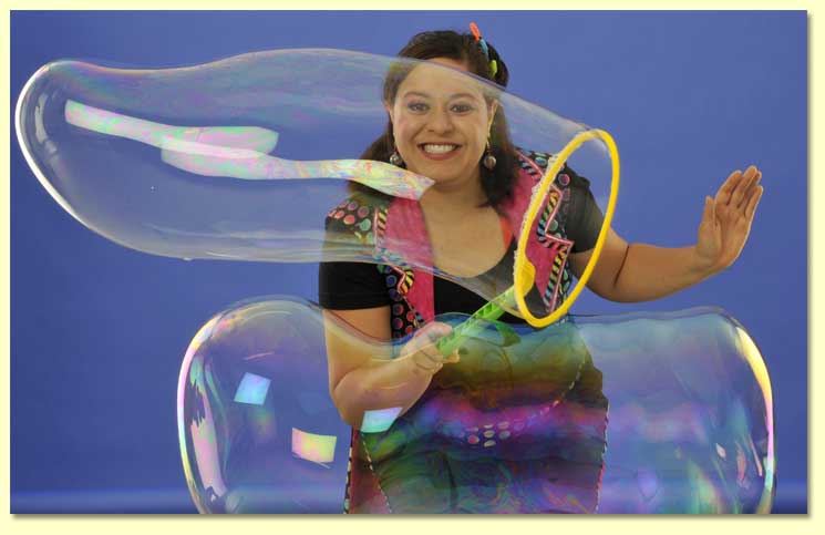 Large photo of the Bubble Lady making long bubbles with a bubble wand.