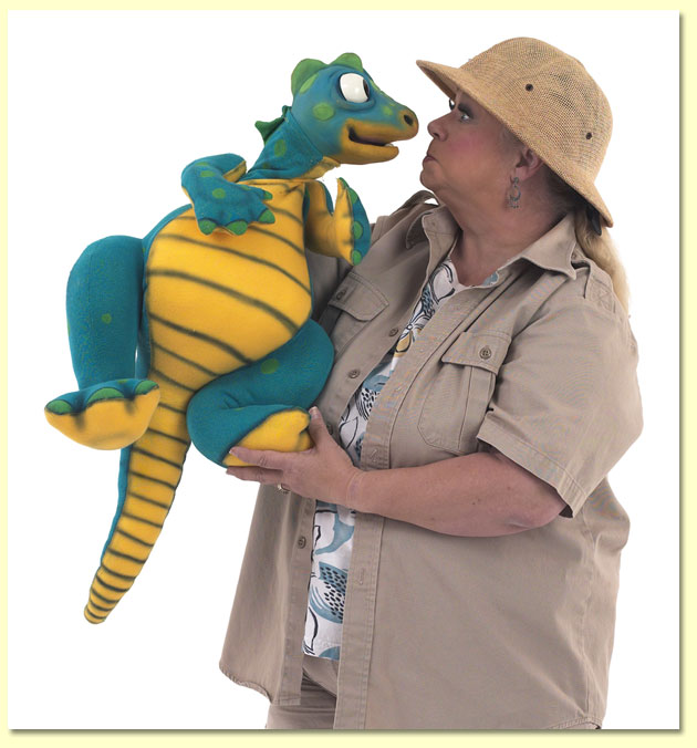 Large photo of ventriloquist and puppeteer Margaret Clauder, dressed as Paleo-Maggie, with a dinosaur puppet.