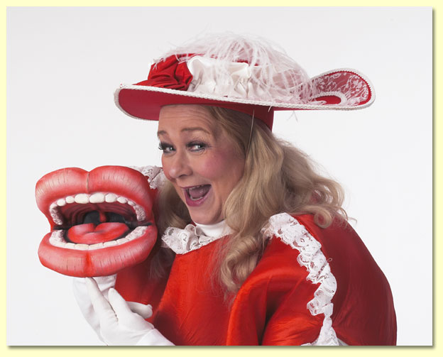 Photograph of Margaret as Lovey Dovey holding a giant lips puppet.