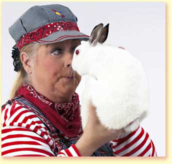 Photograph of <b>Margaret Clauder</b> as Engineer Maggie, holding a white rabbit. - small_engineer_maggie_library