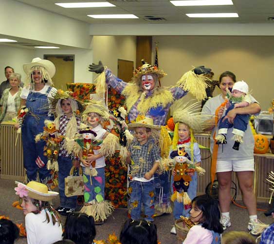 Photograph of Patchy with scarecrow costume contestants.